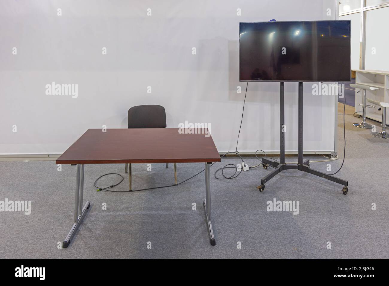 Presentation Flat Screen TV and Empty Work Desk in Meeting Room With
