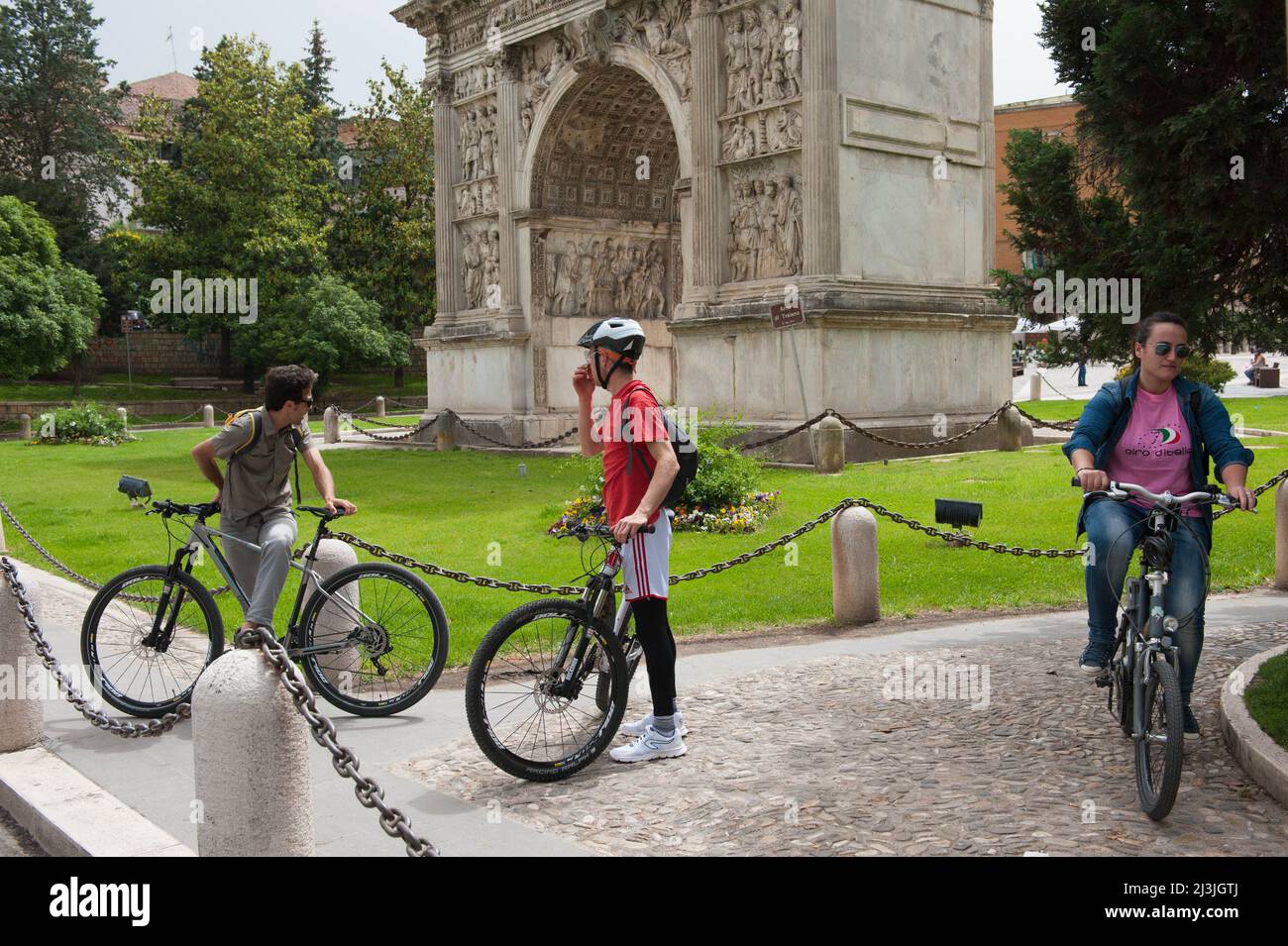 Benevento, Italy 11/05/2016: young people on bikes, Arch of Trajan. ©Andrea Sabbadini Stock Photo
