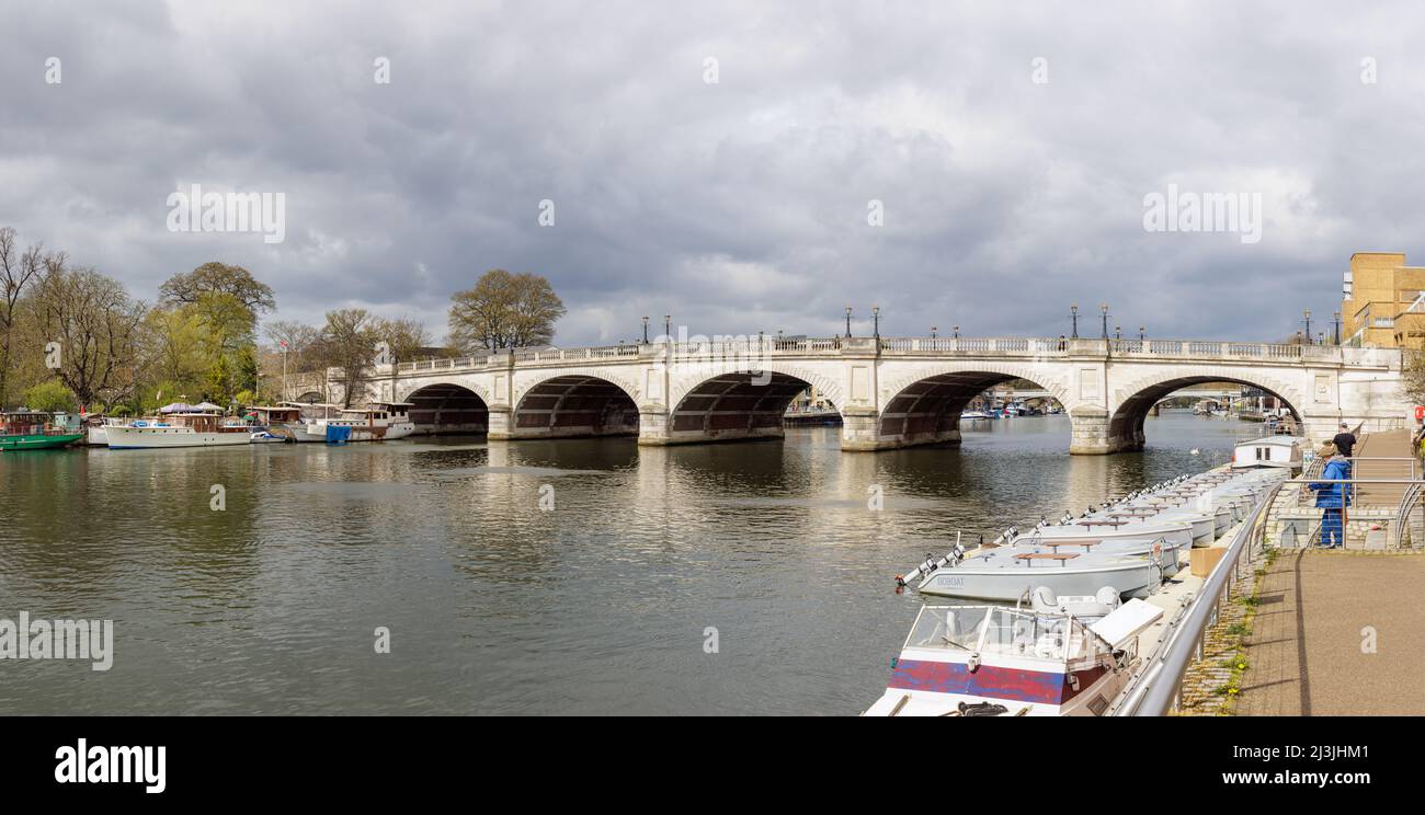 Kingston upon Thames, London, UK, April 5th 2022: Private and small hire boats moored on the banks of the River Thames by the elegant Kingston Bridge. Stock Photo