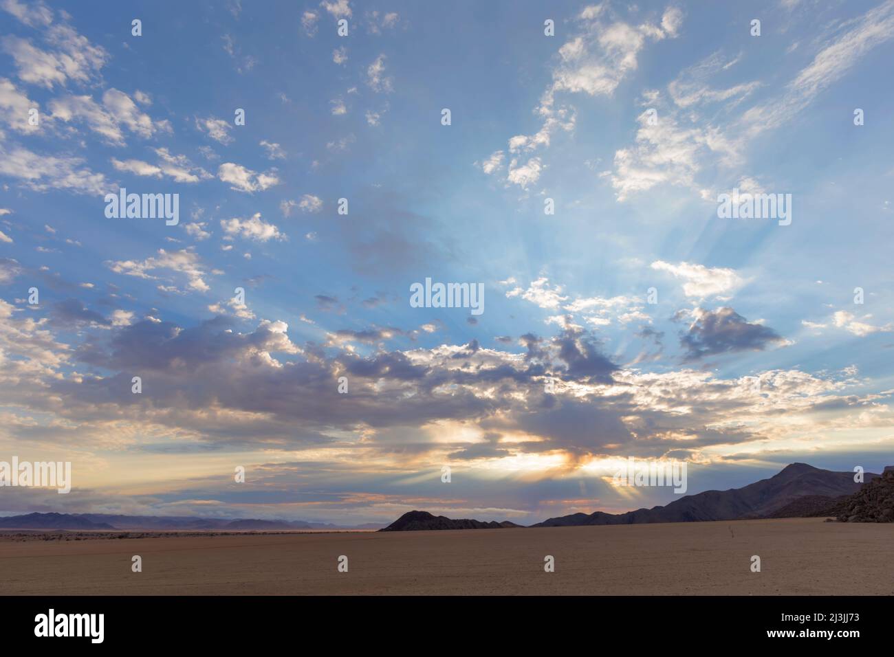 Sun rays through the clouds at sunrise Namib Desert Namibia Stock Photo