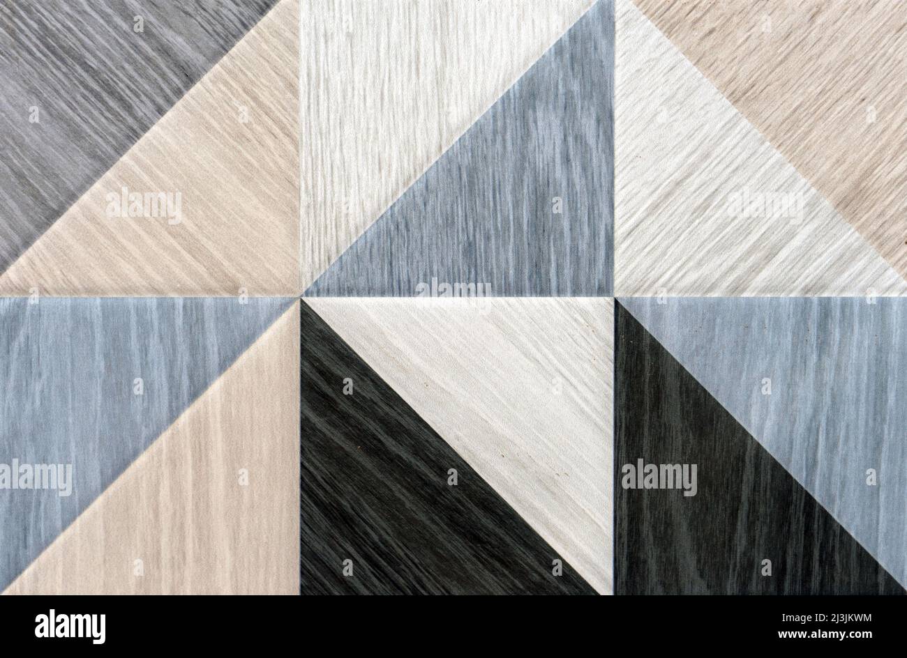 Ceramic tiles in the form of triangles with different textures of wood. Stock Photo