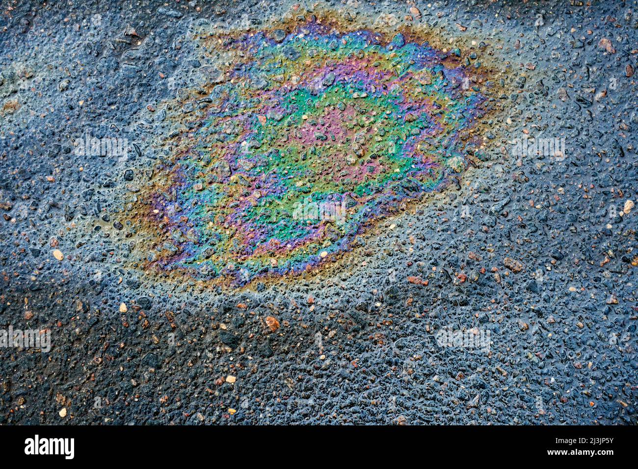 Oil stain, Gas Stain drop from the Car on the Parking Lot Floor Stock