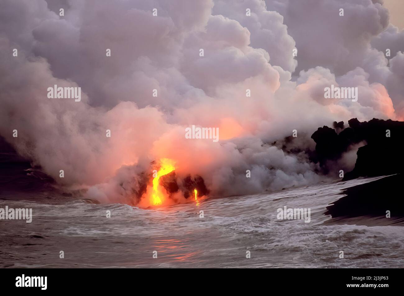 Billowing Steam and Noxious Gasses as Kilauea Flows into the Sea, Hawaii Volcanoes Nat'l Park, Big Island of Hawaii Stock Photo