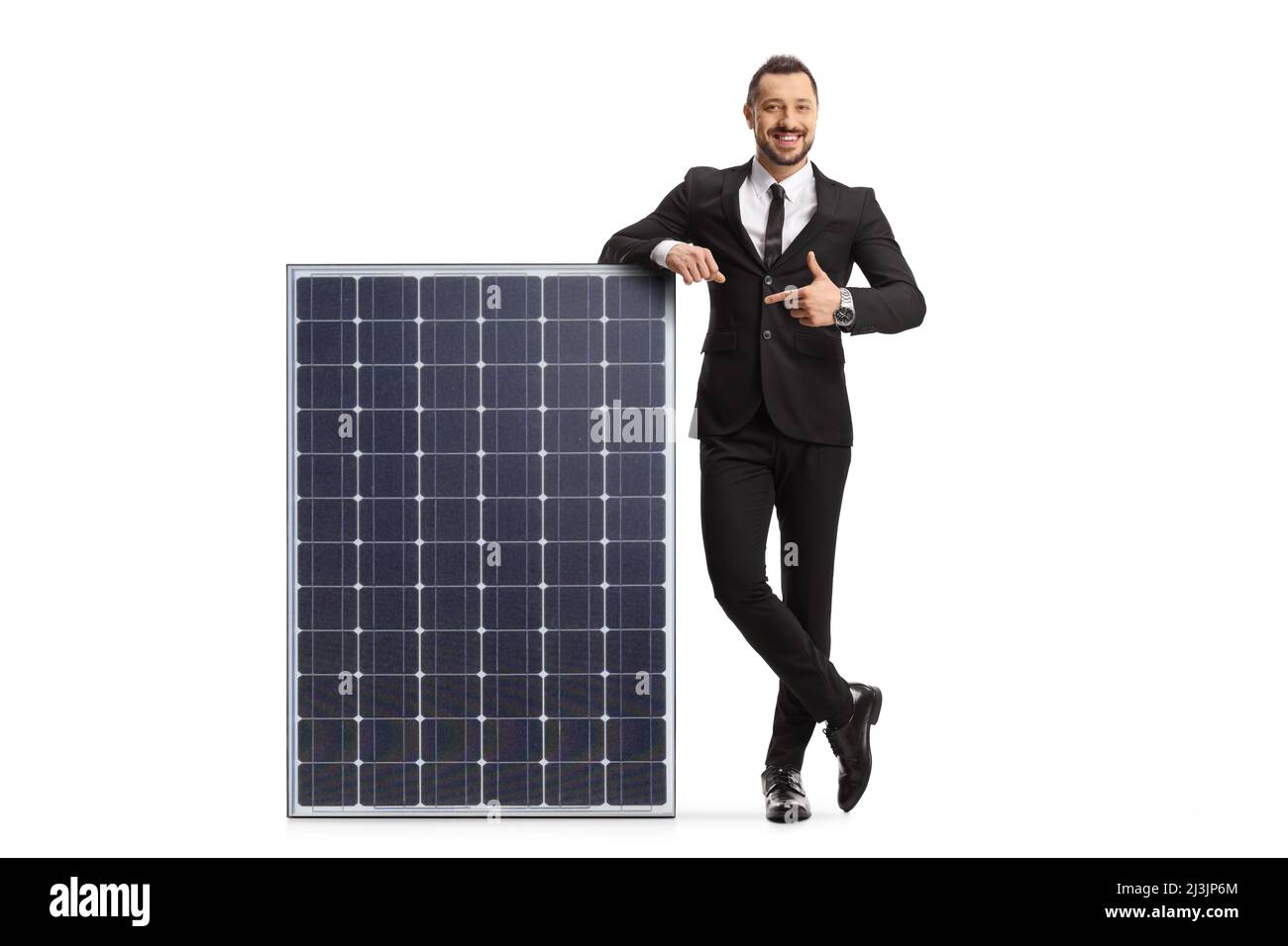 Full length portrait of a businessman leaning on a solar panel and ...