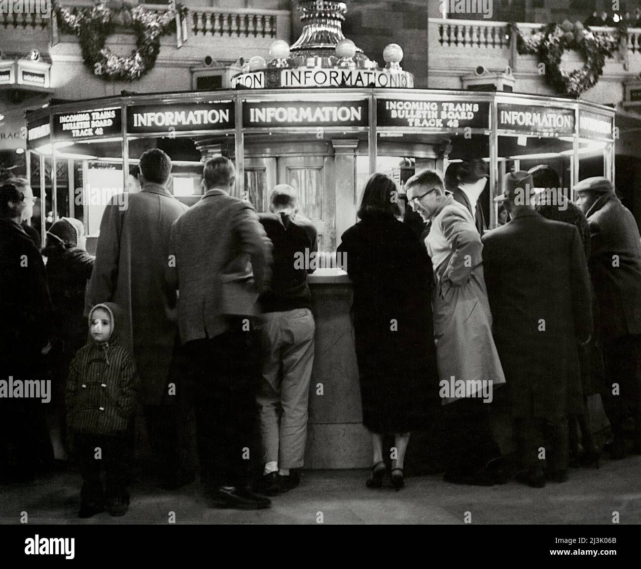 Group of People gathered around Information Booth, Grand Central Terminal, New York City, New York, USA, Angelo Rizzuto, Anthony Angel Collection, December 1957 Stock Photo