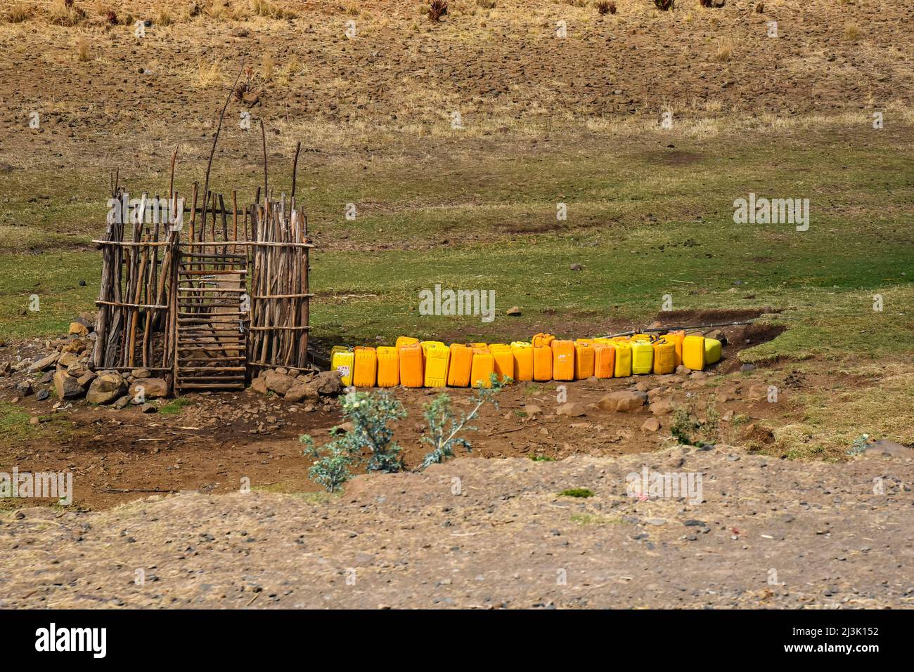 Water containers at a well in rural Ethiopia; Ethiopia Stock Photo