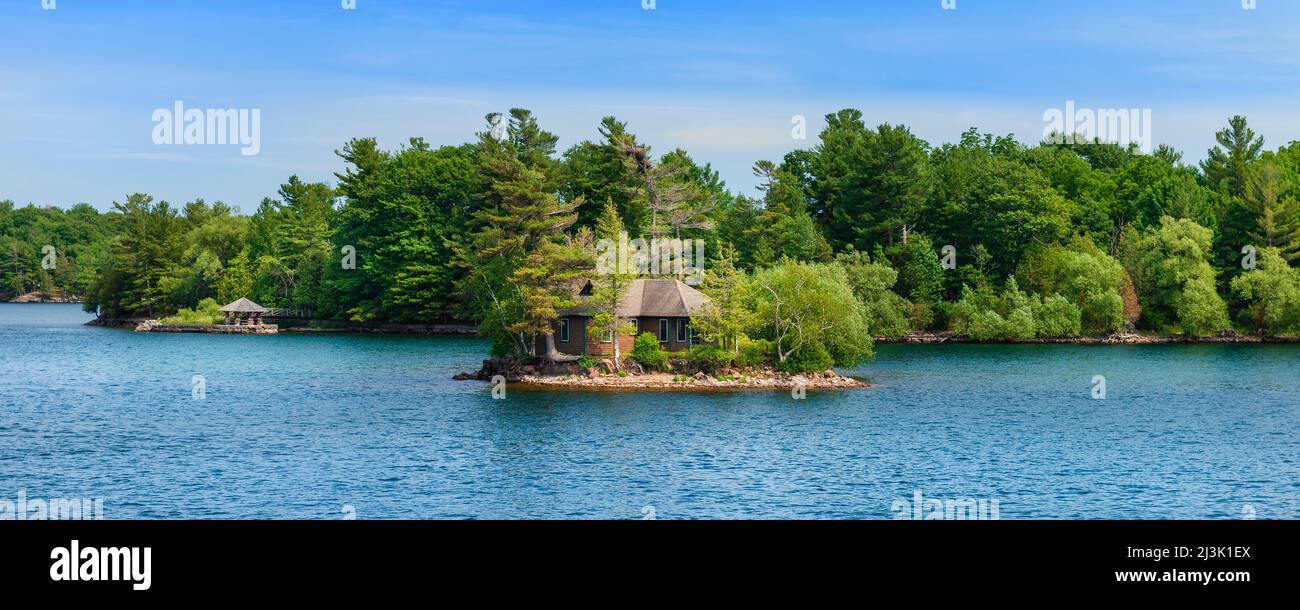 Small island with a house and trees in the Thousand Islands; Ontario ...