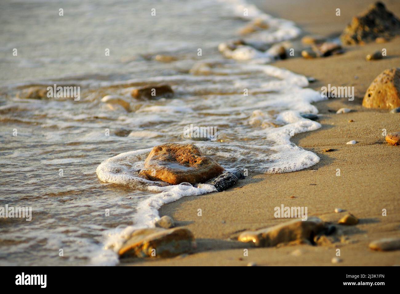 Sand, stones and foam on a beach, Six-Fours-les-Plages, Var, Provence-Alpes-Côte d'Azur, France Stock Photo