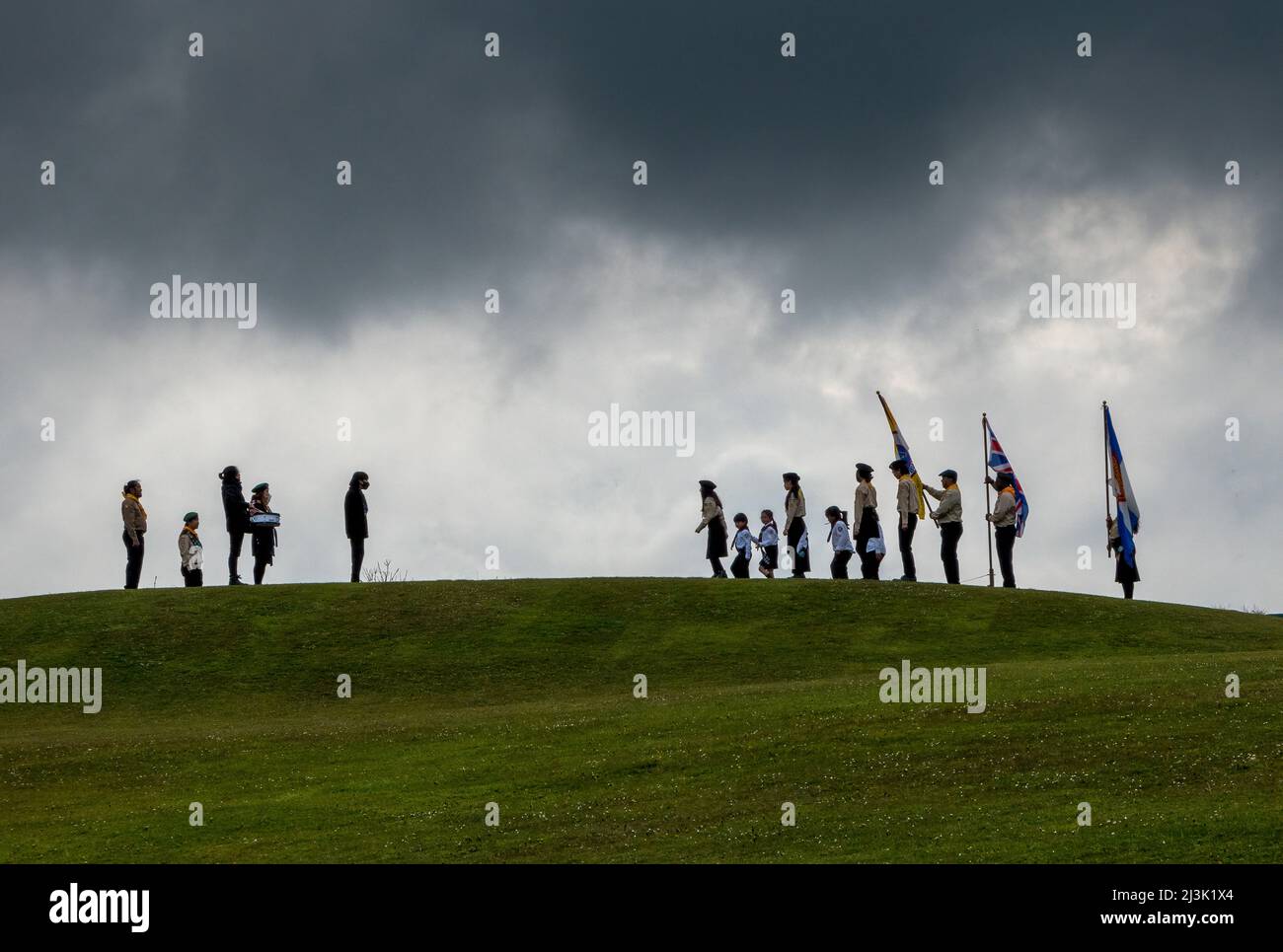 Outdoor ceremony for a children's club on a hillside in England with flags and a drummer; South Shields, Tyne and Wear, England Stock Photo