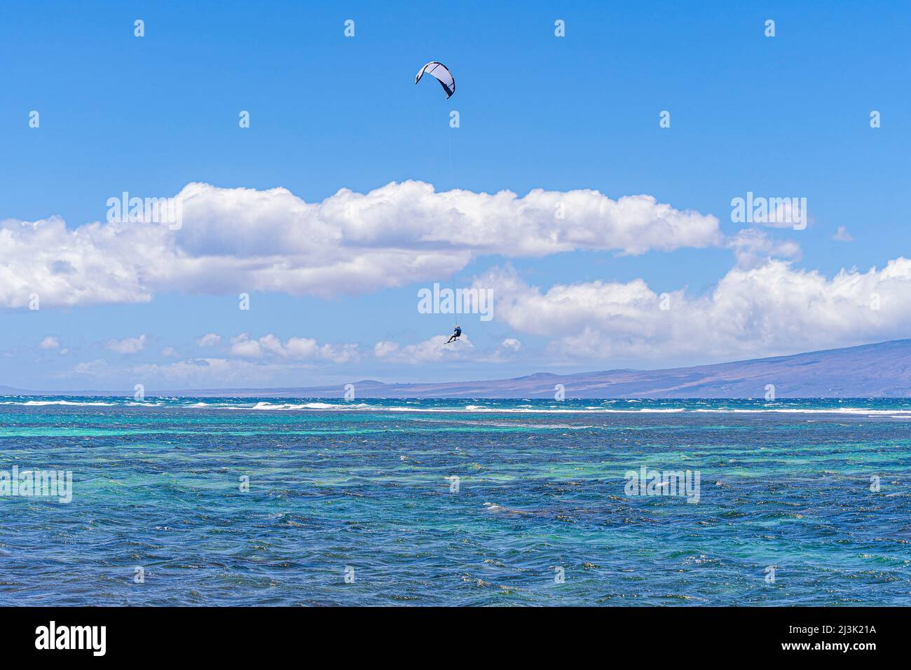 Kiteboarding off Shipwreck Beach, with the rider in midair; Lanai