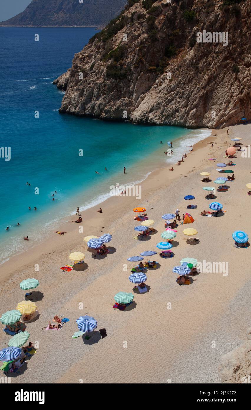 Tourists and beach umbrellas on Kaputas beach, near Kas, Turkey Turkey Stock Photo