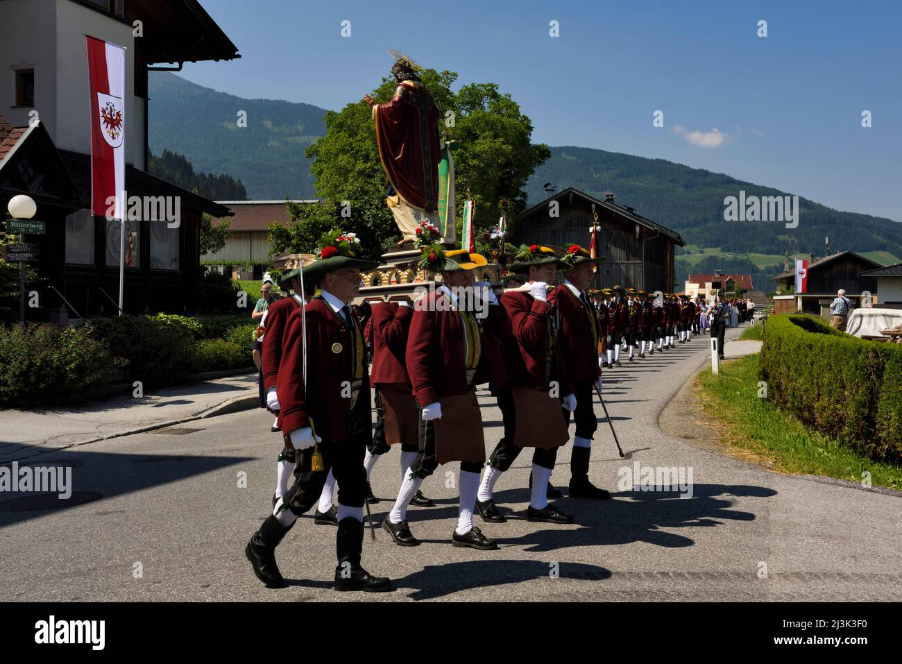 The procession through Weerberg Village to celebrate Herz-Jesu Festival. The Herz-Jesu festival was born out of the Napoleonic War. When in 1796, Napo Stock Photo