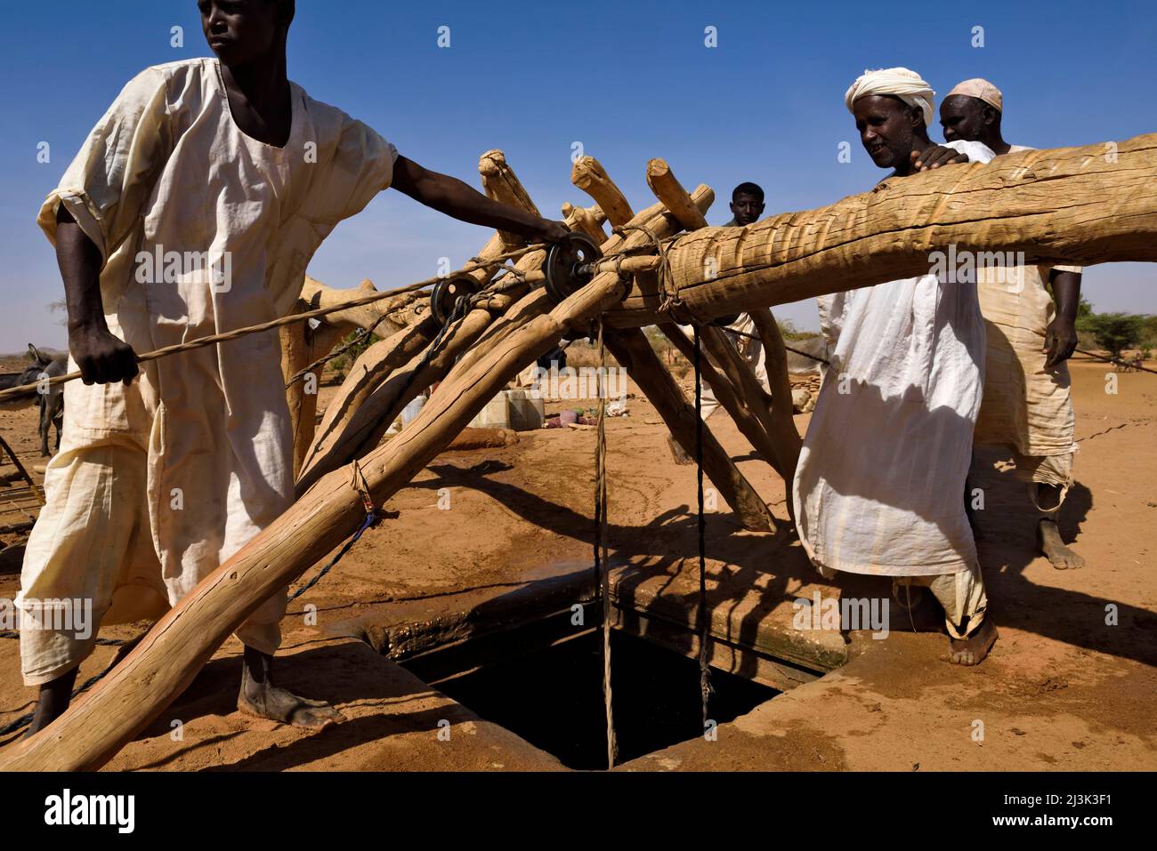 Sudanese farmers collect water from a 72m deep well close to the archeological site led by the Berlin group and Karla Kroeper at Naqa Stock Photo