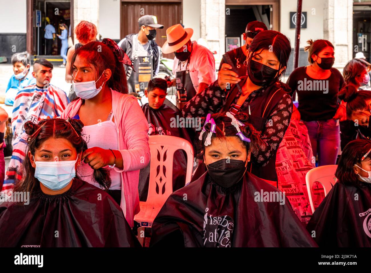Young Peruvians having their hair cut off in Arequipa, Peru in response to a Social Media request for hair to soak up oil from the Callao oil spill. Stock Photo