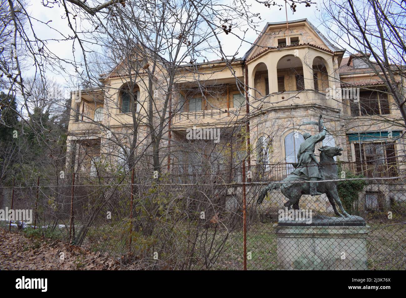 A sculpture of a hunter riding a horse in front of the summer Palace of