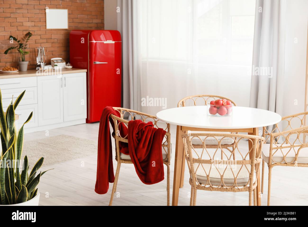 Interior of modern kitchen with dining table, stylish refrigerator and ...