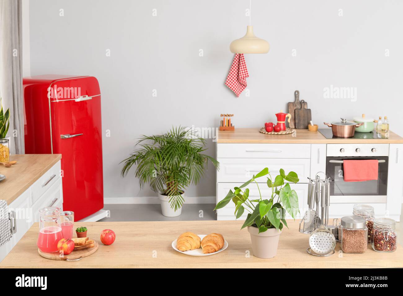 Modern counters and stylish refrigerator in kitchen Stock Photo Alamy