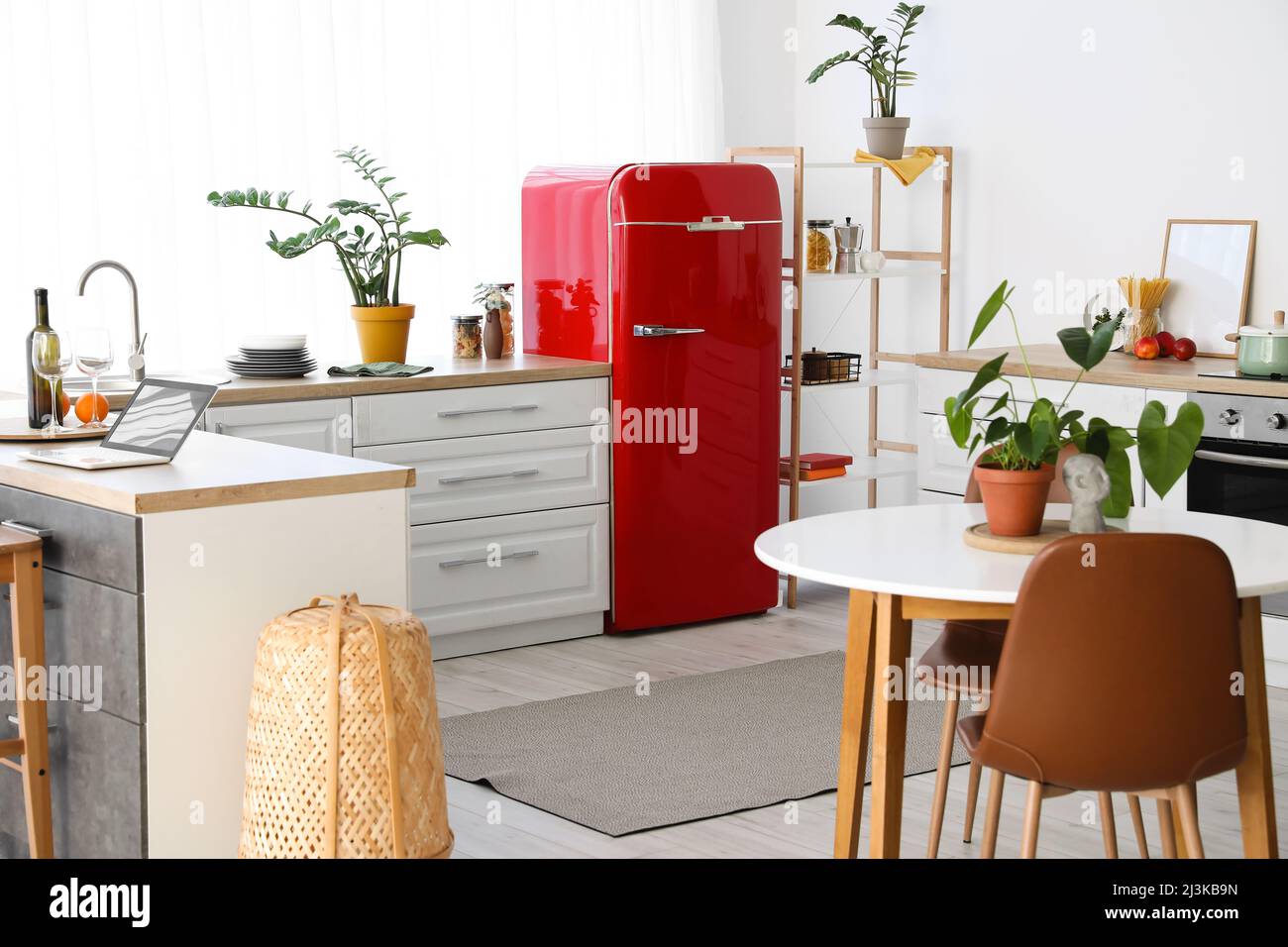 Interior of modern kitchen with stylish refrigerator, counters and ...