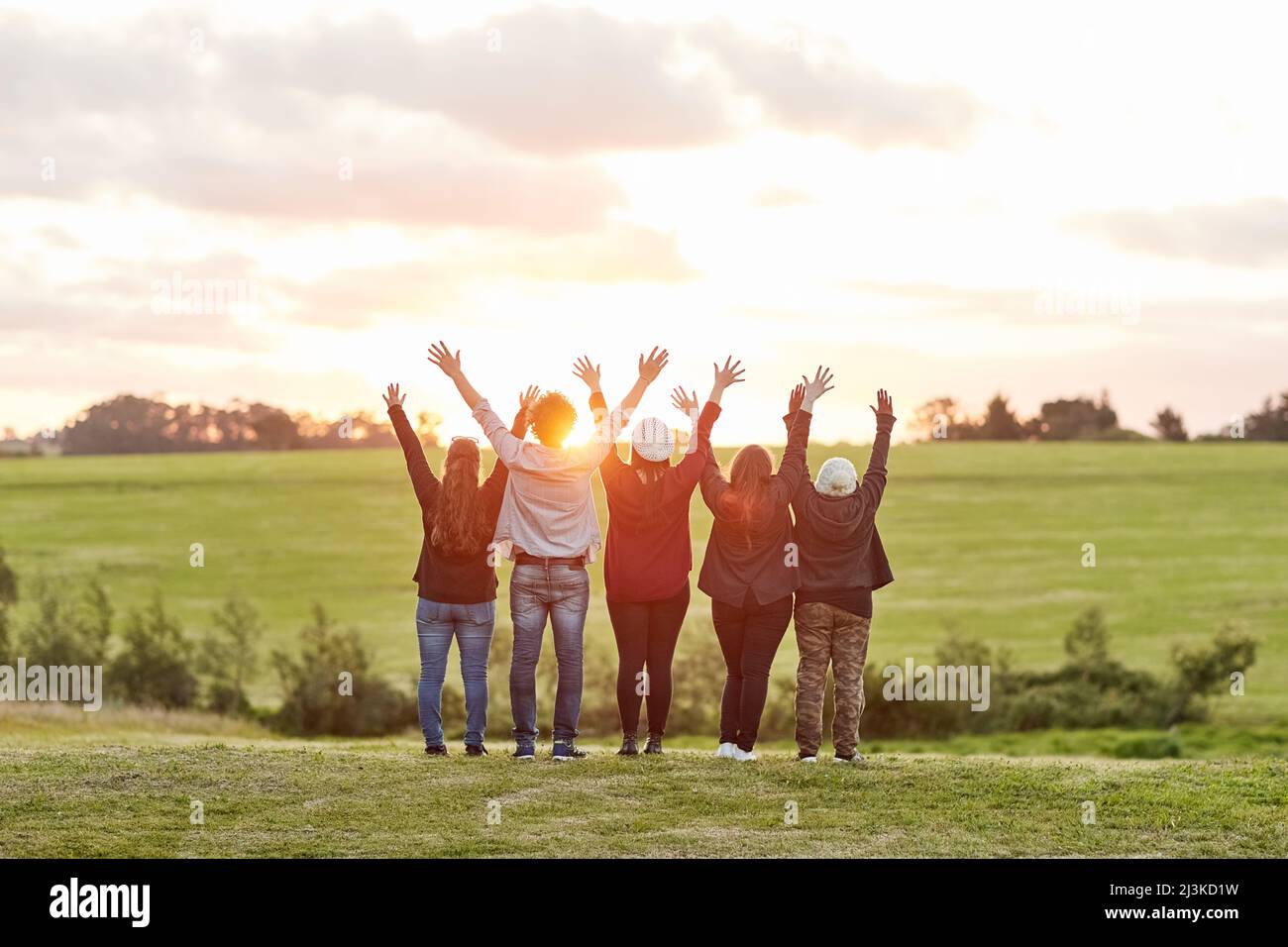 Living in the moment. Rearview shot of a group of friends admiring the view together on a weekend getaway. Stock Photo