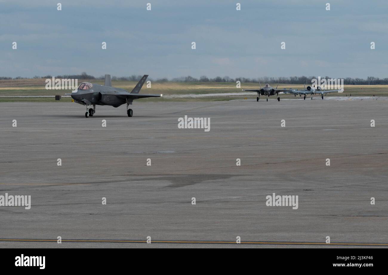 Two F-35 Lightning II assigned to Hill Air Force Base, Utah and two A-10 Thunderbolt IIs with the 442nd Fighter Wing taxi at Whiteman Air Force Base, Missouri, April 5, 2022. Exercise Agile Tiger is designed to enhance our ability to communicate, collaborate, and operate with our service partners.  (U.S Air Force Photo by Senior Airman Christina Carter) Stock Photo