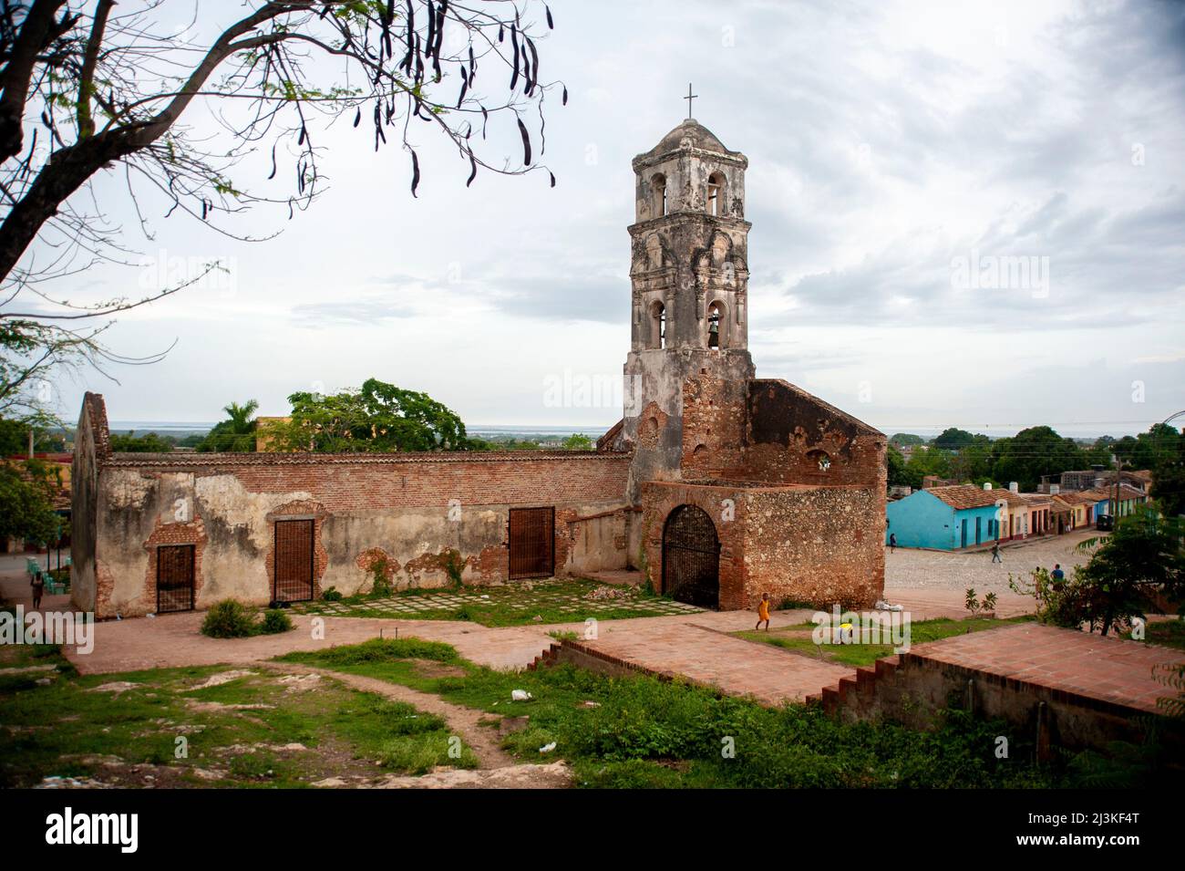 Santa Ana Church. a dilapidated old church in Trinidad, Cuba with a view of the sky and the Caribbean ocean in the distance. Stock Photo