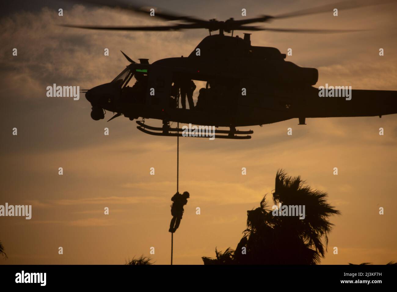 U.S. Marines assigned to Marine Aviation Weapons and Tactics Squadron One (MAWTS-1), conduct fast rope insertion exercises during Weapons and Tactics Instructor (WTI) course 2-22, at K-9 Village, Yuma Proving Grounds, Arizona, April 2, 2022. WTI is a seven-week training event hosted by MAWTS-1, providing standardized advanced tactical training and certification of unit instructor qualifications to support Marine aviation training and readiness, and assists in developing and employing aviation weapons and tactics. (U.S. Marine Corps photo by Lance Cpl. Daniel Childs) Stock Photo