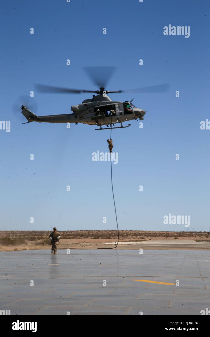 U.S. Marines with 1st Battalion, 2d Marine Regiment, 2d Marine Division (MARDIV), conduct fast-rope training during Weapons and Tactics Instructor (WTI) course 2-22 at Laguna Army Airfield, Yuma Proving Ground, Arizona, April 2, 2022. WTI is a seven-week training event, hosted by Marine Aviation Weapons and Tactics Squadron One, which emphasizes the development of small task-organized unit experimentation across all warfighting functions, as well as enhance the battalion's ability to conduct command and control, fire-support planning, intelligence functions, and logistical support to distribut Stock Photo