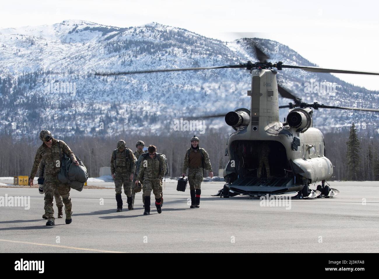 U.S. Airmen assigned to Detachment 1, 3rd Air Support Operations Squadron, and U.S. Soldiers assigned to 17th Combat Sustainment Support Battalion, U.S. Army Alaska, disembark a U.S. Army CH-47 Chinook helicopter assigned to B Company, 2-211th General Support Aviation Battalion, Alaska Army National Guard, while completing airborne operations at Joint Base Elmendorf-Richardson, Alaska, April 7, 2022. The 3rd ASOS completed the helicopter jump on Geronimo Drop Zone, maximizing total-force training to demonstrate short-notice mission readiness in an arctic environment. (U.S. Air Force photo by S Stock Photo