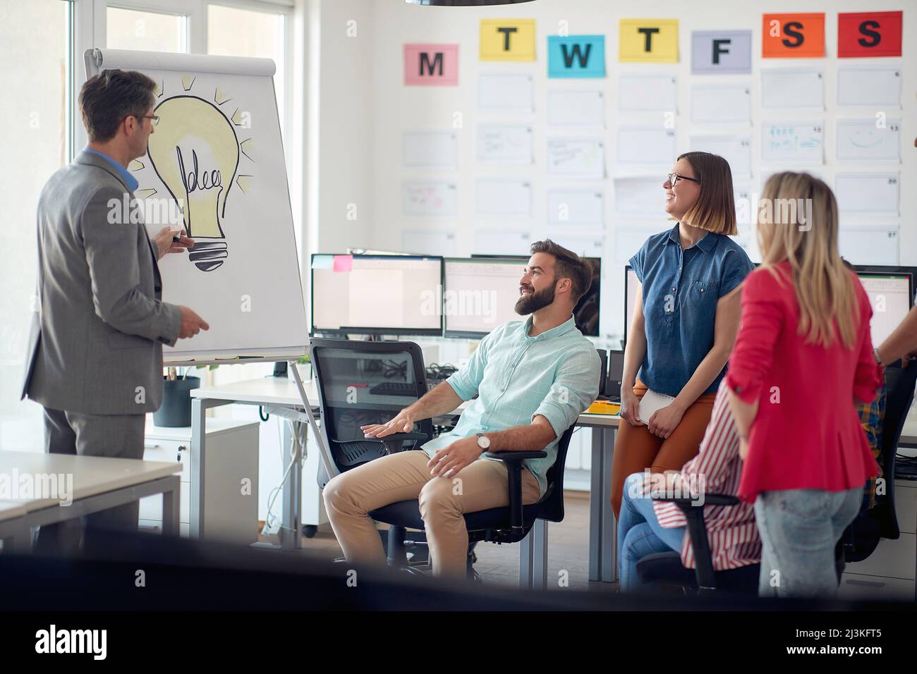 Group of young ambitious employees brainstorming together in the office ...