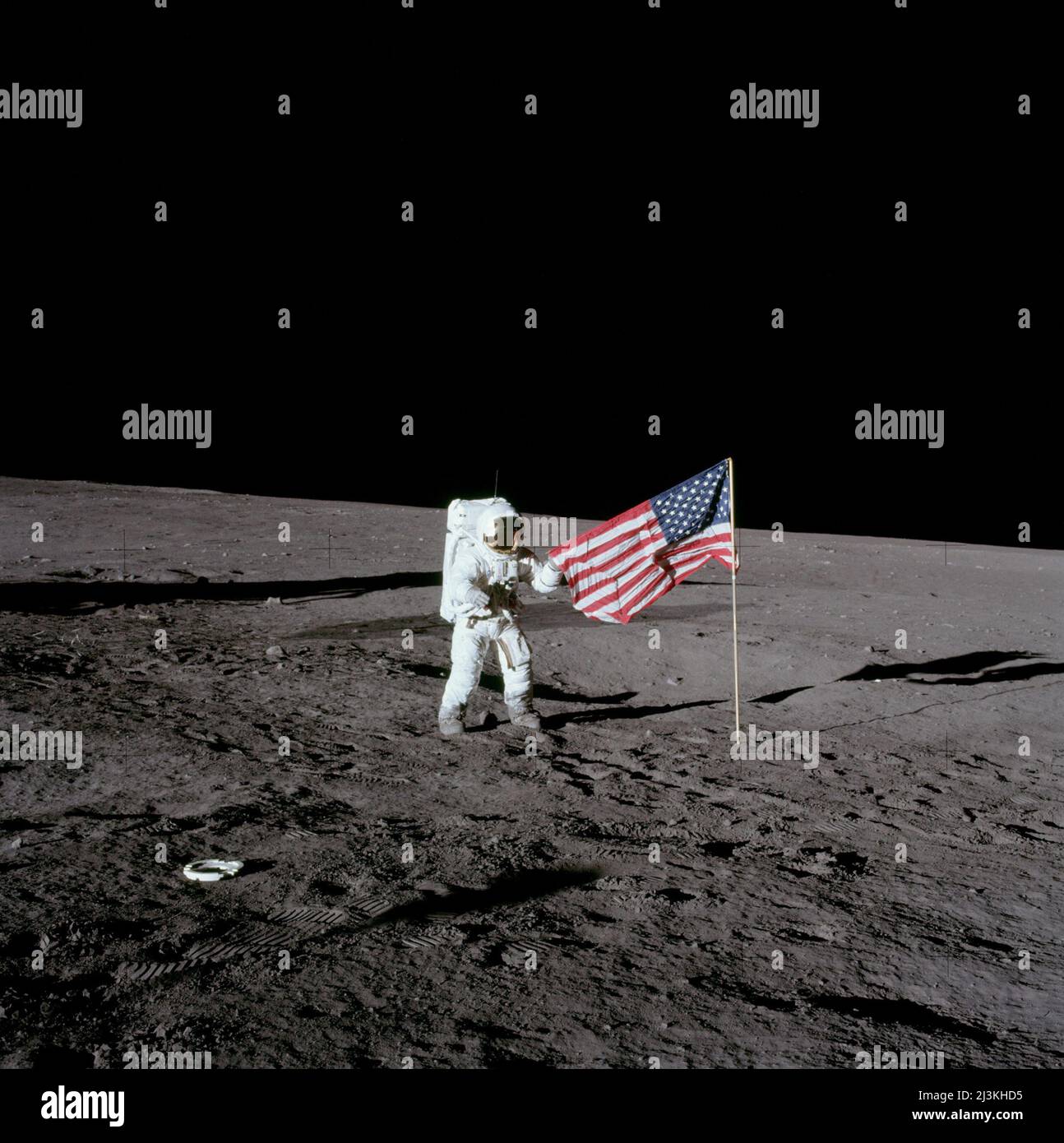 Astronaut Charles Conrad beside the US flag during Apollo 12 mission to the moon. Stock Photo