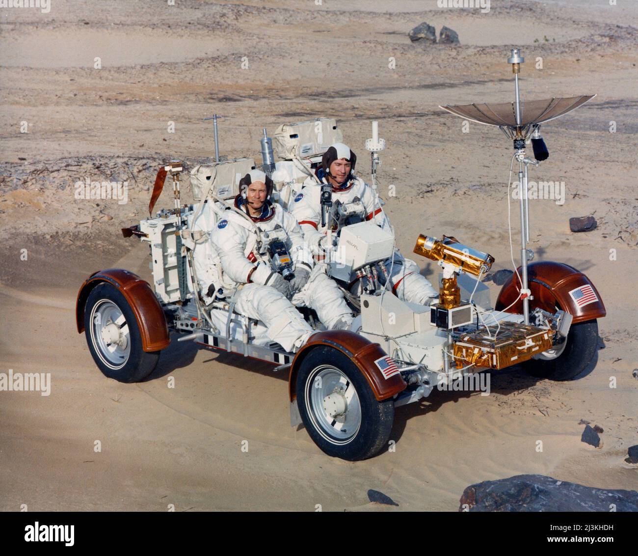 Apollo 16 astronauts John Young (right), and Charles Duke, maneuver a training version of the lunar roving vehicle about a field at the Kennedy Space Center simulated to represent the lunar surface Stock Photo