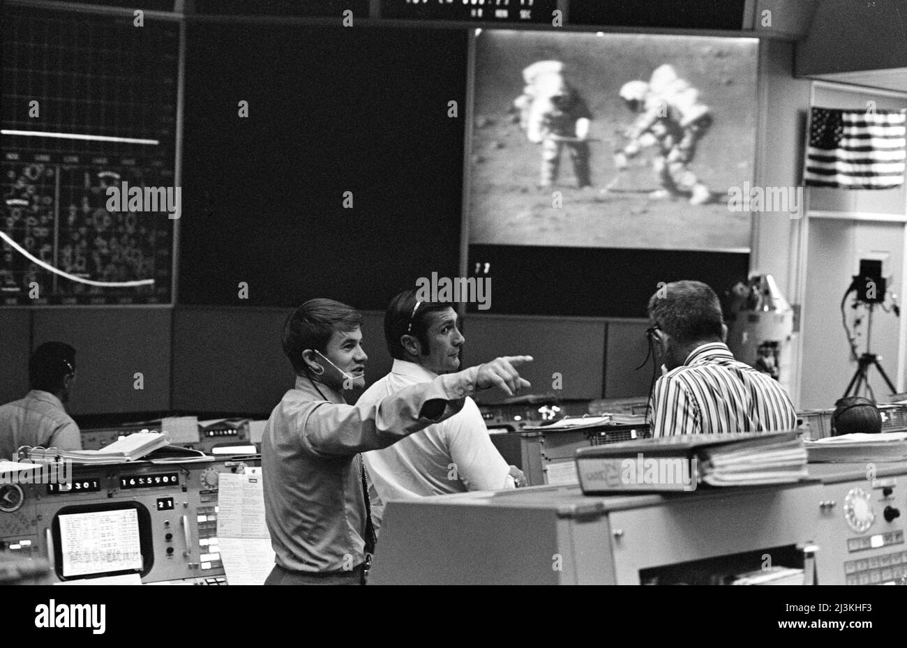 Mission Operations Control Room (Mission Control) in Houston during the third Apollo 15 moonwalk, with astronauts Jim Irwin (left) and Dave Scott (right). CapCom Joe Allen (left) is pointing toward the back of the room, Stock Photo
