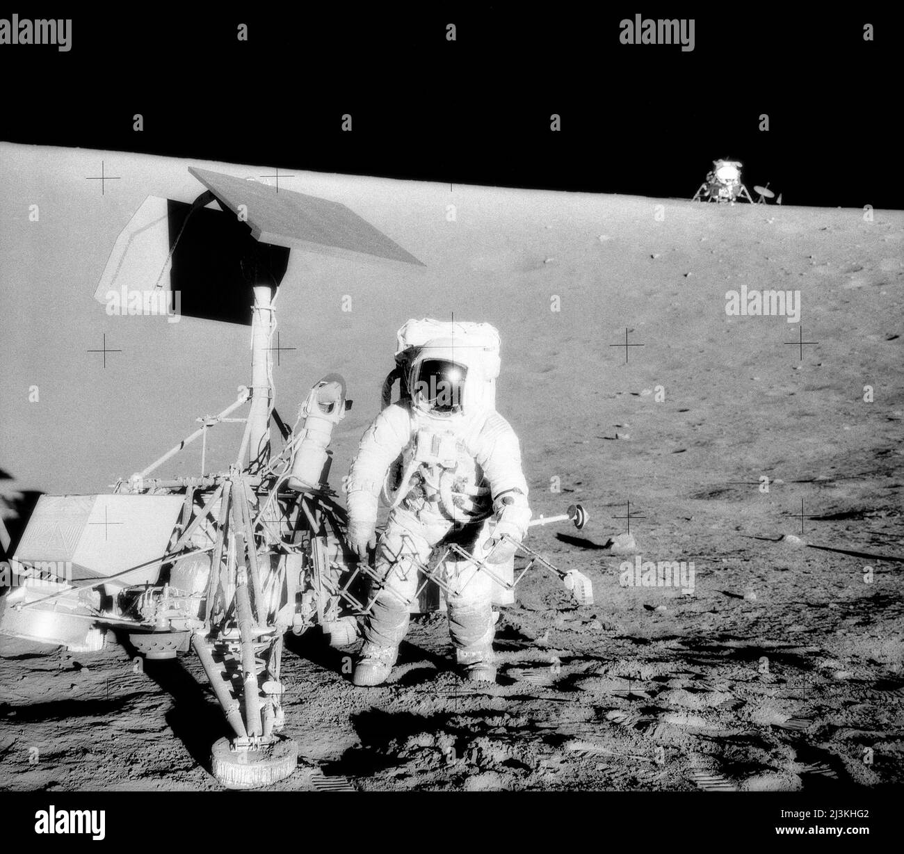 Charles Conrad, Apollo 12 Commander, examining the unmanned Surveyor III spacecraft which landed on the moon in 1967. The Lunar Module (LM) 'Intrepid' is in the right background. This picture was taken by astronaut Alan Bean, Lunar Module pilot. The 'Intrepid' landed on the Moon's Ocean of Storms only 600 feet from Surveyor III. Stock Photo