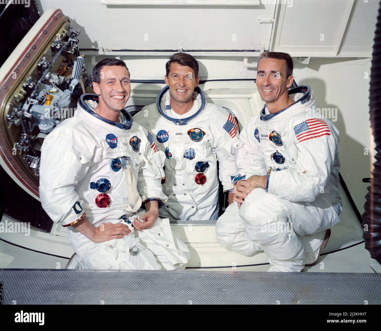 The prime crew of the first manned Apollo space mission, Apollo 7.  From left to right are: Command Module pilot, Don Eisele, Commander, Walter Schirra and Lunar Module pilot, Walter Cunningham. The photograph was taken inside the White Room which is attached to the crew access arm. From here astronauts get into the spacecraft. Stock Photo