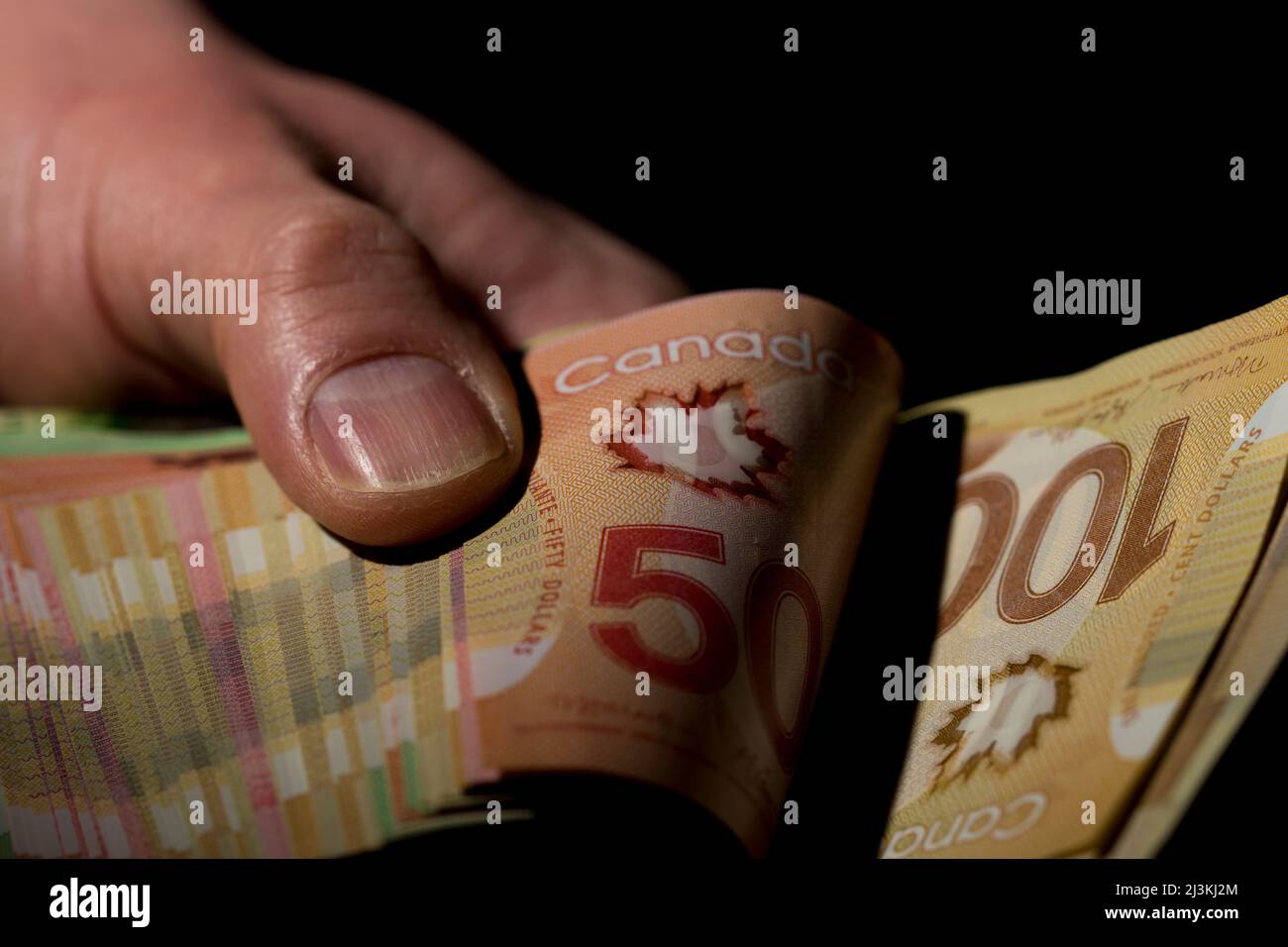 Counting money Canadian money close up. Paper cash dollar bills being counted. Stock Photo