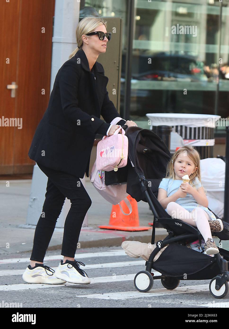 Walking in soho with her daughters new york city hires stock