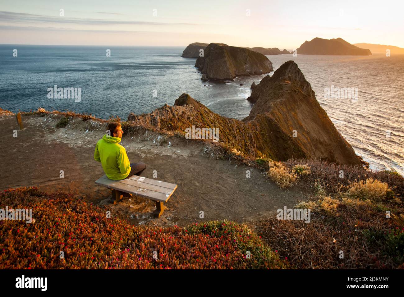 A hiker watches the sunset from 'Inspiration Point'. Stock Photo