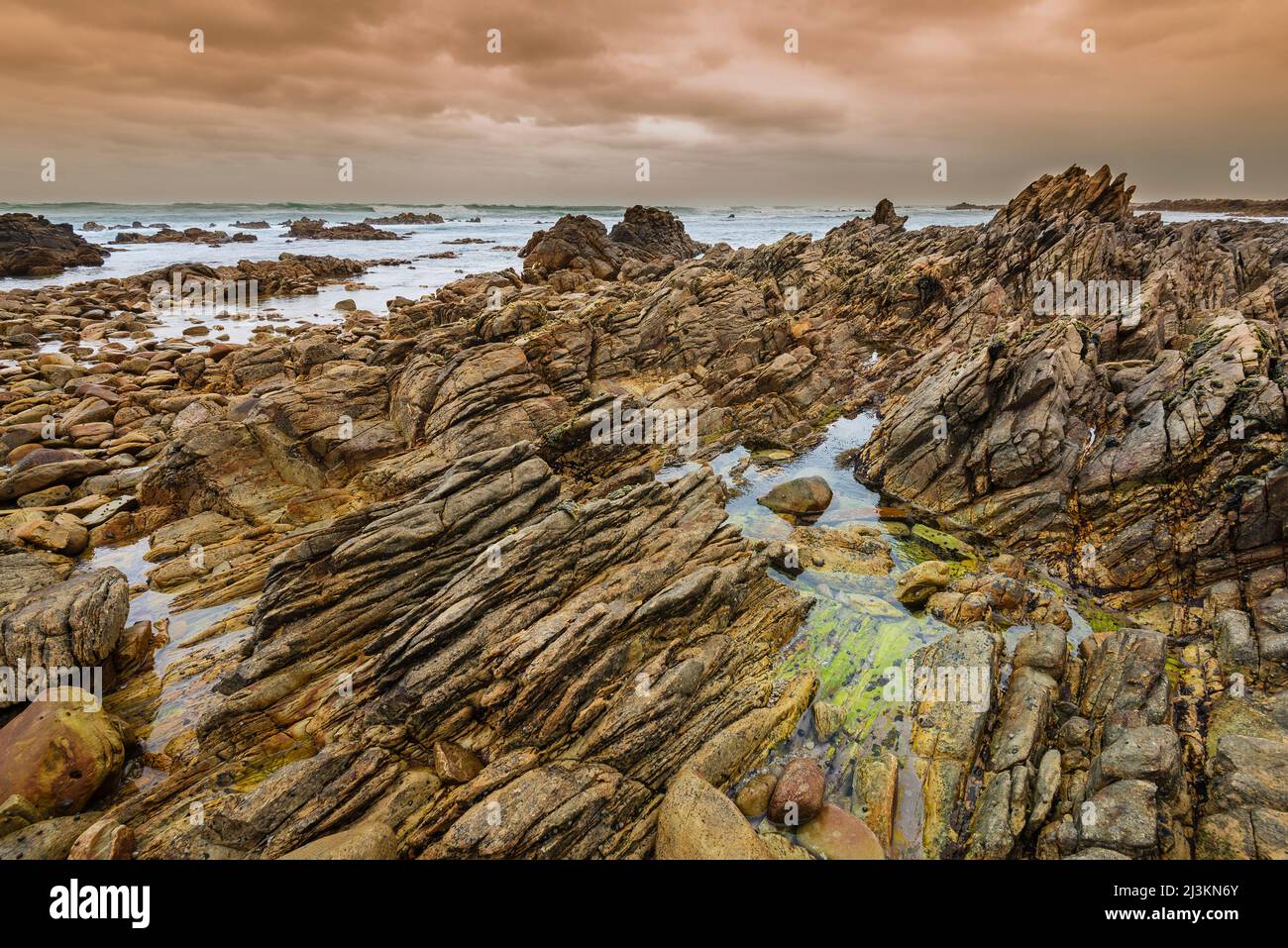 Jagged rock formations on the rocky shore at Cape Agulhas in Agulhas National Park; Western Cape, South Africa Stock Photo