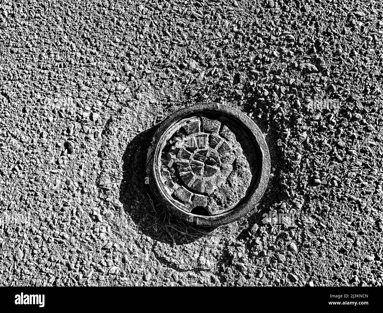 Low angle view of capped water main in residential street Stock Photo