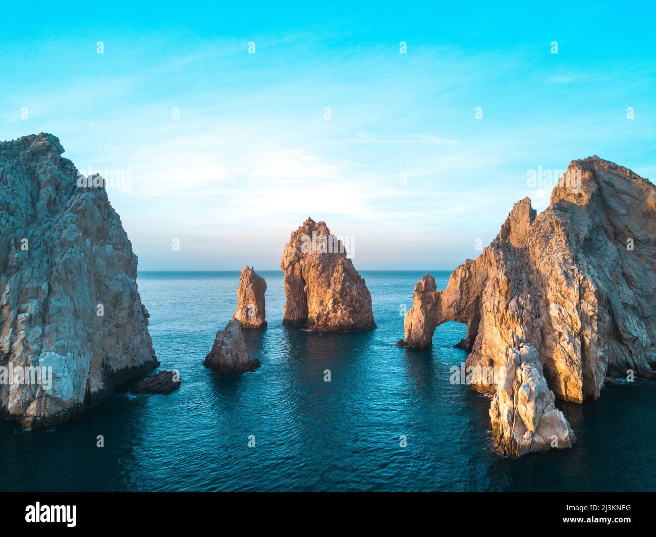 Dramatic rock formations and Arcos de Cabo San Lucas (Arch of Cabo San Lucas) on the coast at Lands End at sunset Stock Photo