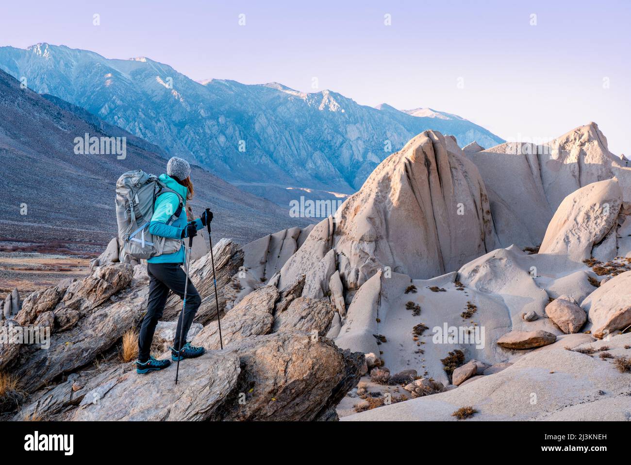 A woman hiking in the Eastern Sierra in winter; Bishop, California, United States of America Stock Photo