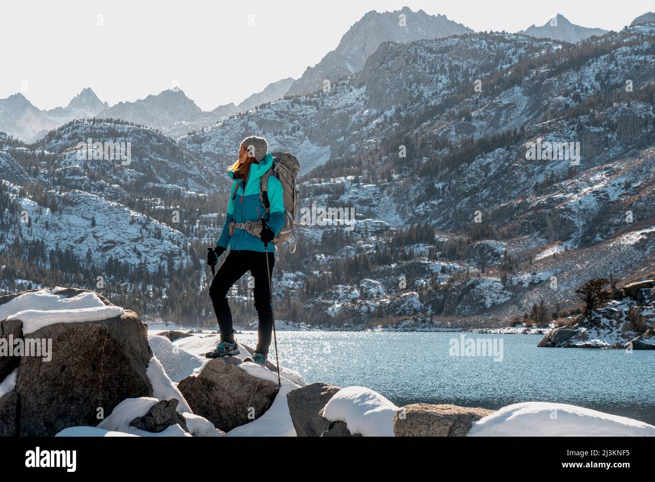 A woman hiking in the Eastern Sierra in winter; Bishop, California, United States of America Stock Photo