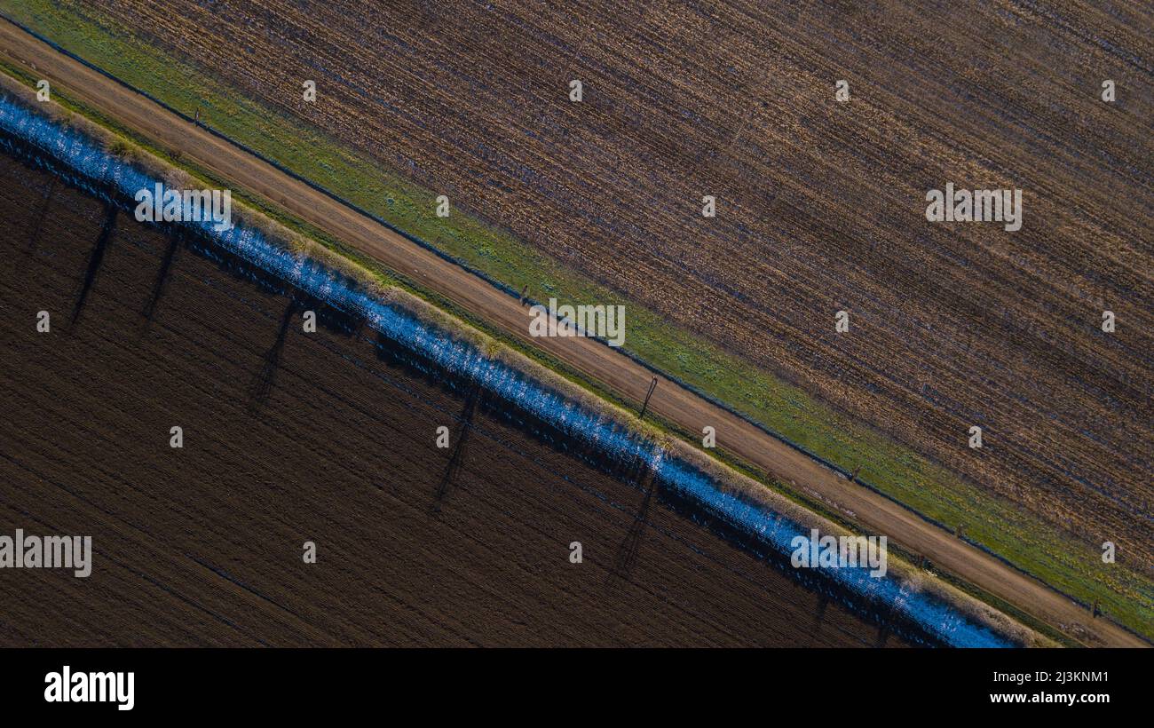 Drone photo of track running past ploughed fields early in the morning, Great Wilbraham; Cambridgeshire, England, United Kingdom Stock Photo