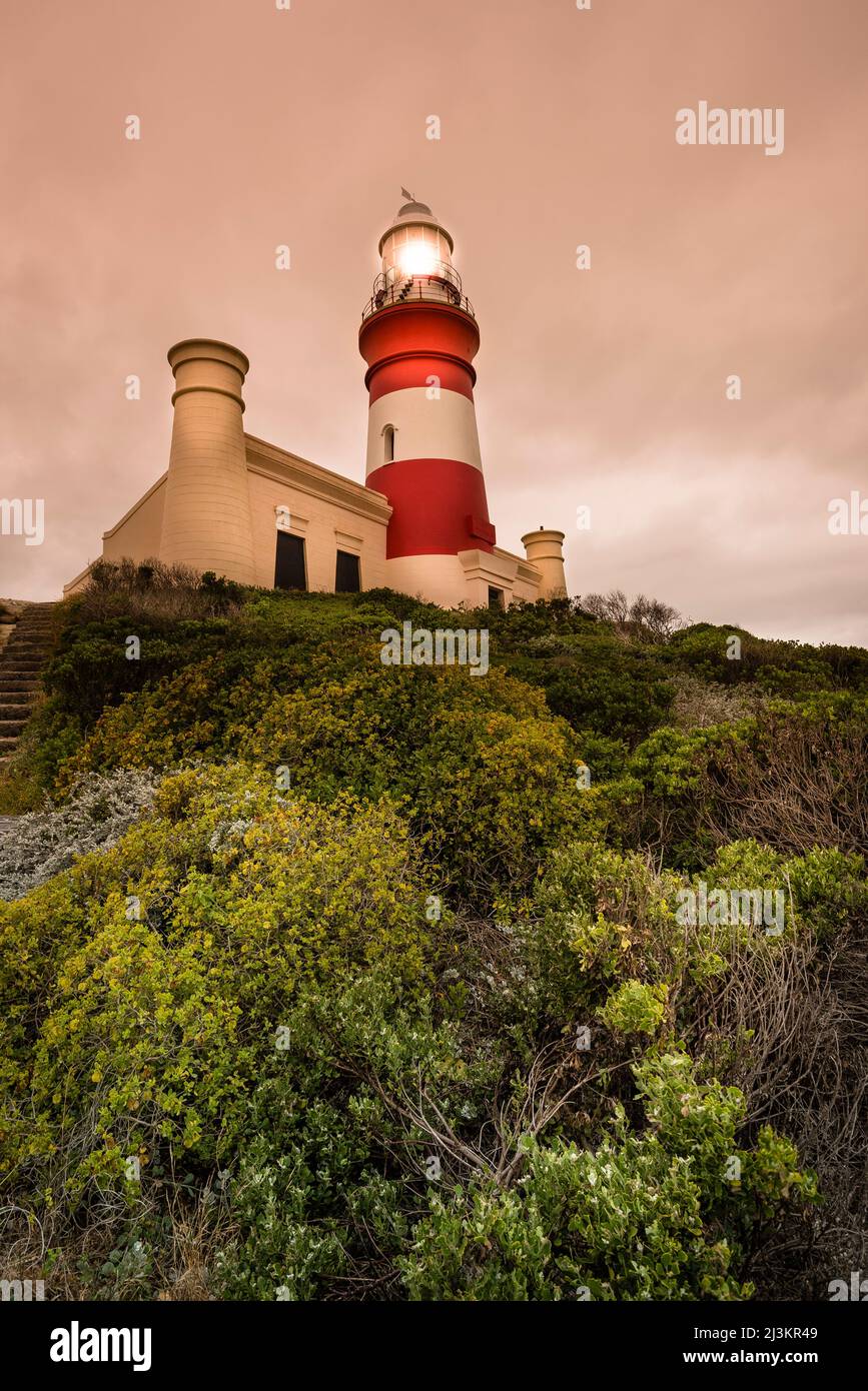Cape Agulhas lighthouse illuminated at dusk, Agulhas National Park