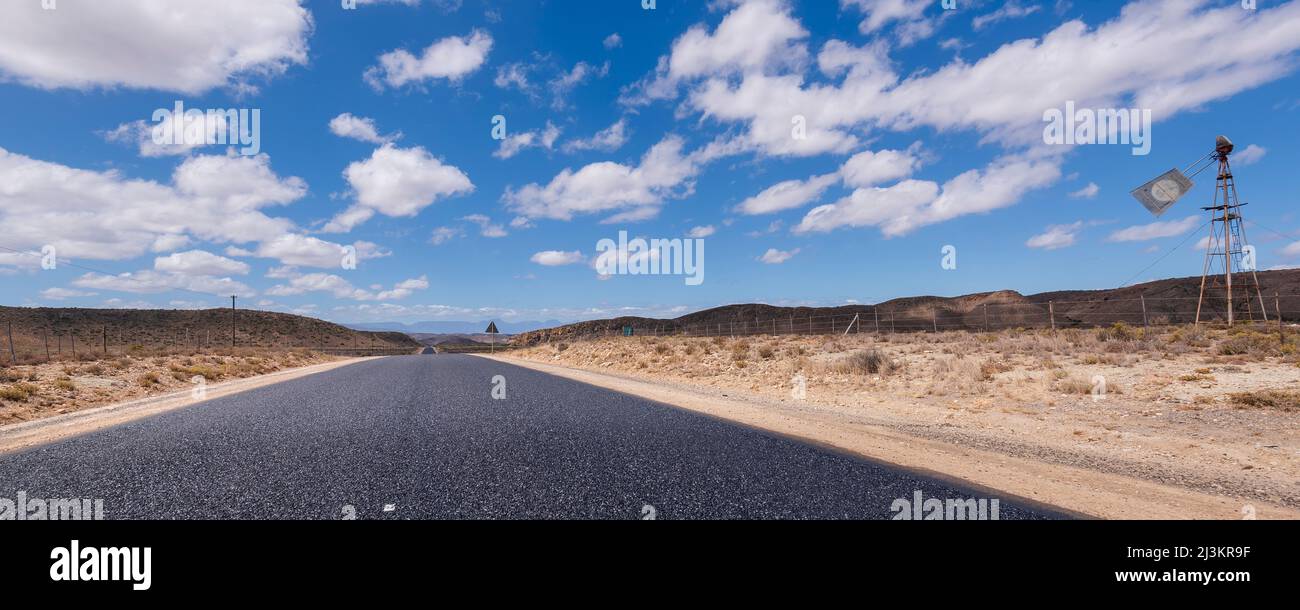 Empty road through an arid landscape, Route 62; Western Cape, South Africa Stock Photo