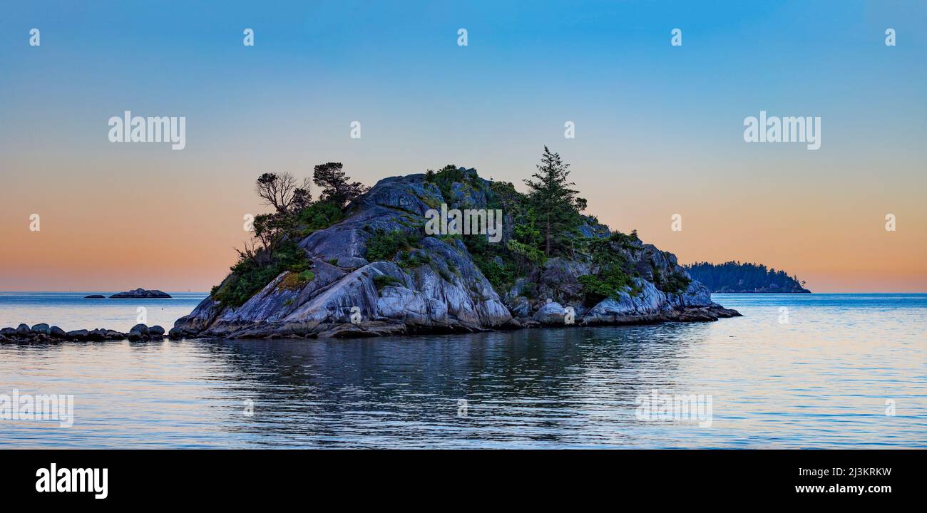 Small landform in the water at sunset in Whytecliff Park, Horseshoe Bay, BC, Canada; British Columbia, Canada Stock Photo