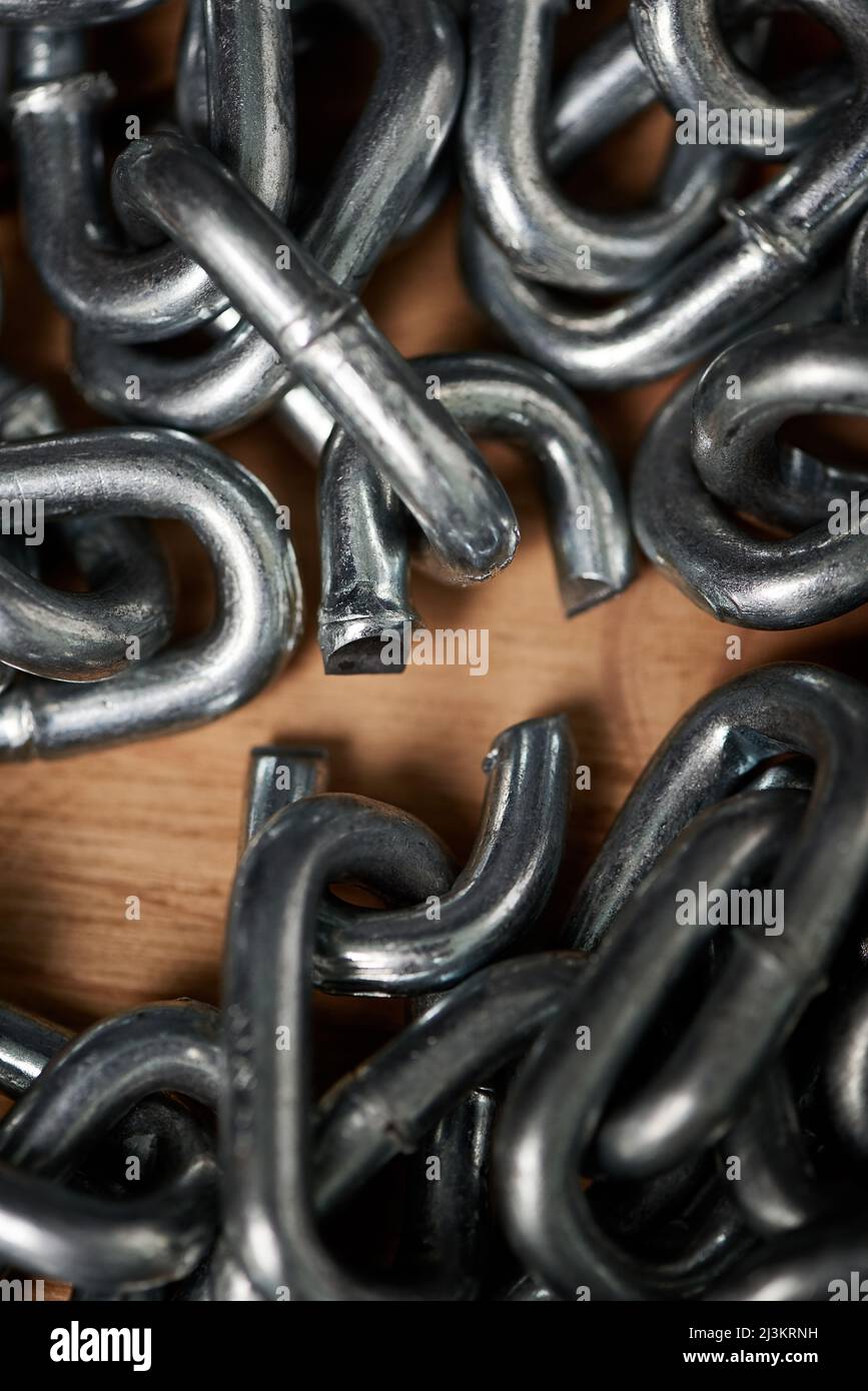 Break free from the chains of life. Shot of metal chains with a broken link. Stock Photo