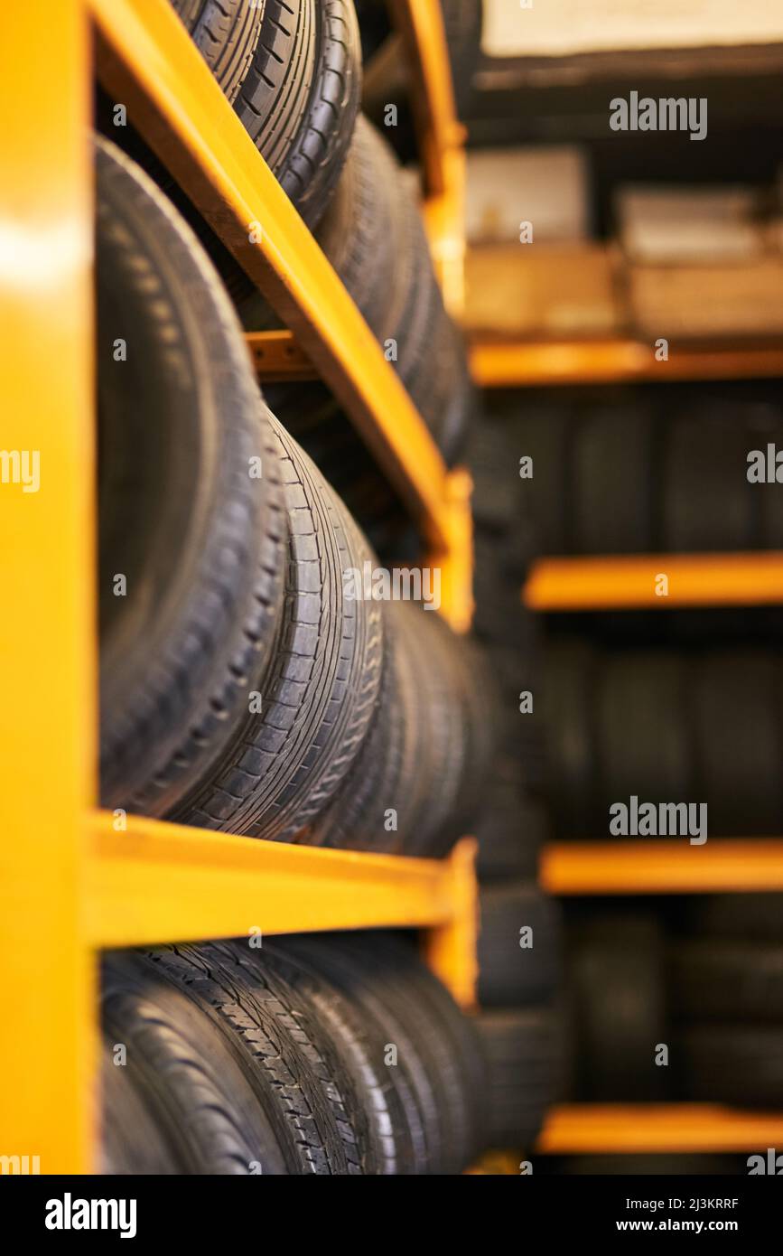 Workshop full of wheels. Closeup shot of a pile of car tyres. Stock Photo