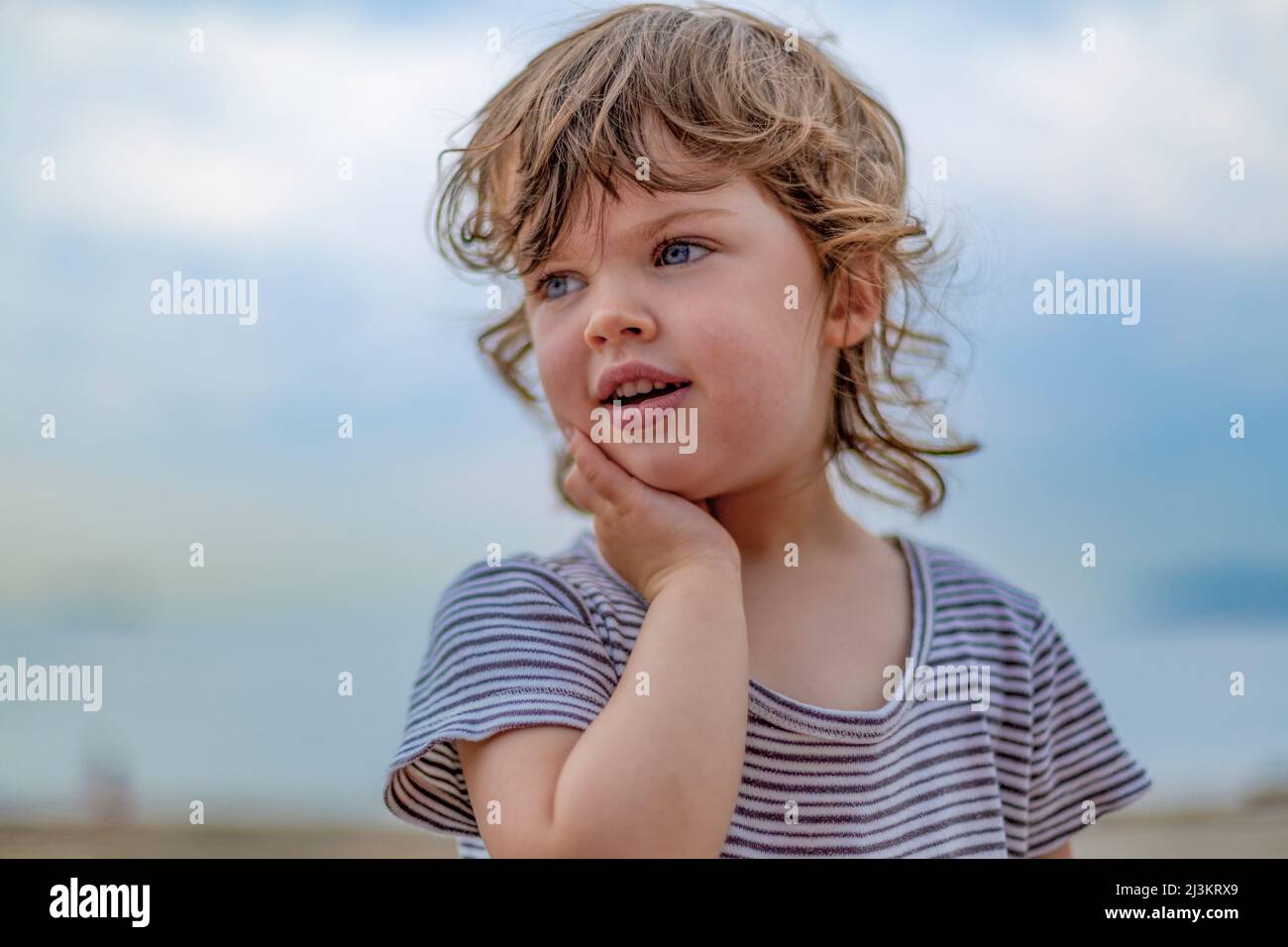 Portrait of a Preschooler girl with curly hair and blue eyes at the beach; West Vancouver, British Columbia, Canada Stock Photo