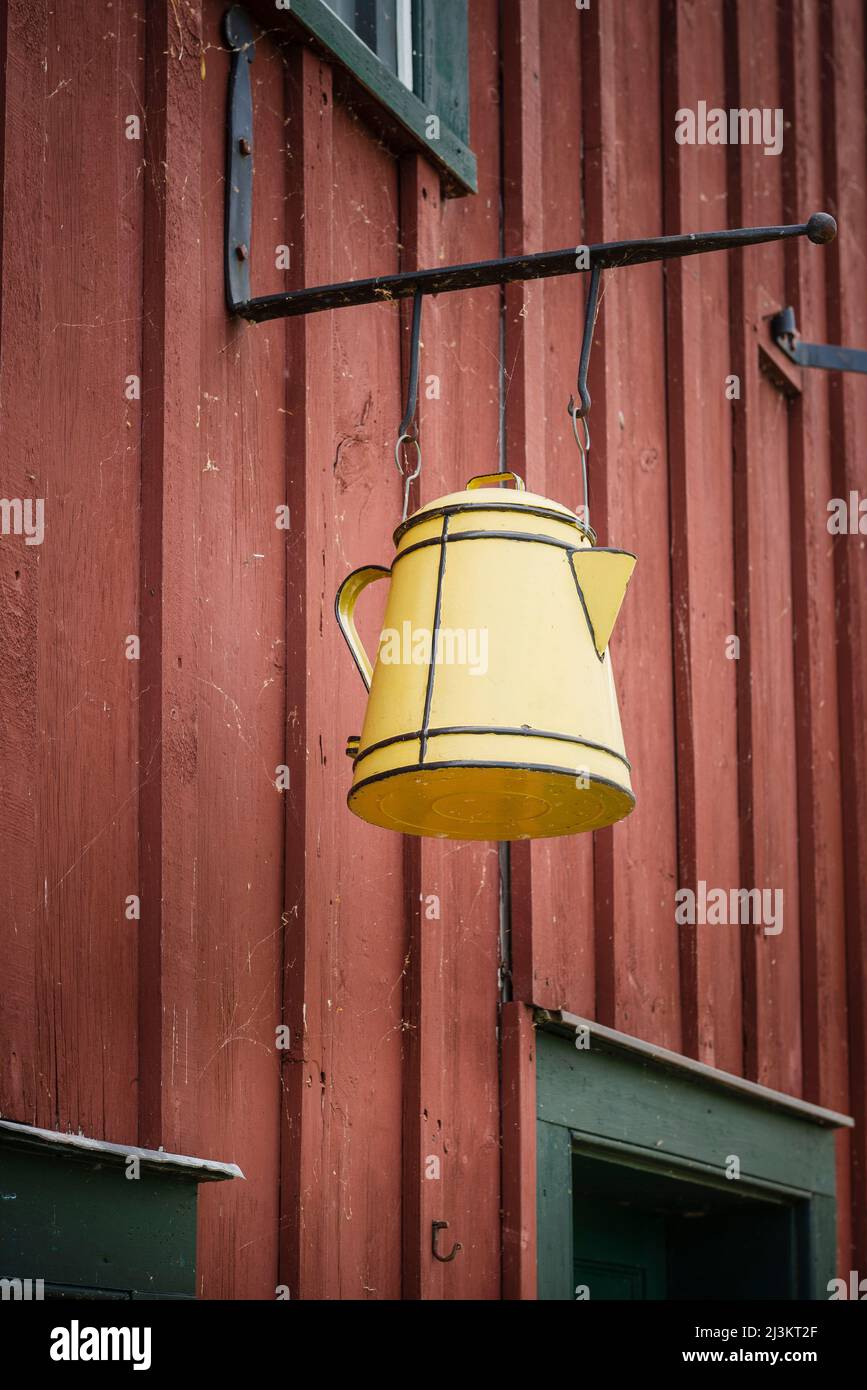 Sign store with a yellow kettle hanging outside at Upper Canada Village; Morrisburg, Ontario, Canada Stock Photo